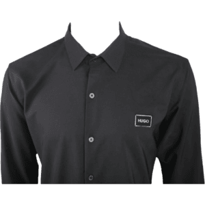 Close-up of HUGO Men's Slim-Fit Long-Sleeve Shirt in Black, featuring logo patch and button details.