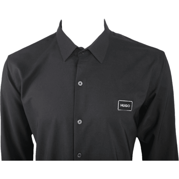 Close-up of HUGO Men's Slim-Fit Long-Sleeve Shirt in Black, featuring logo patch and button details.